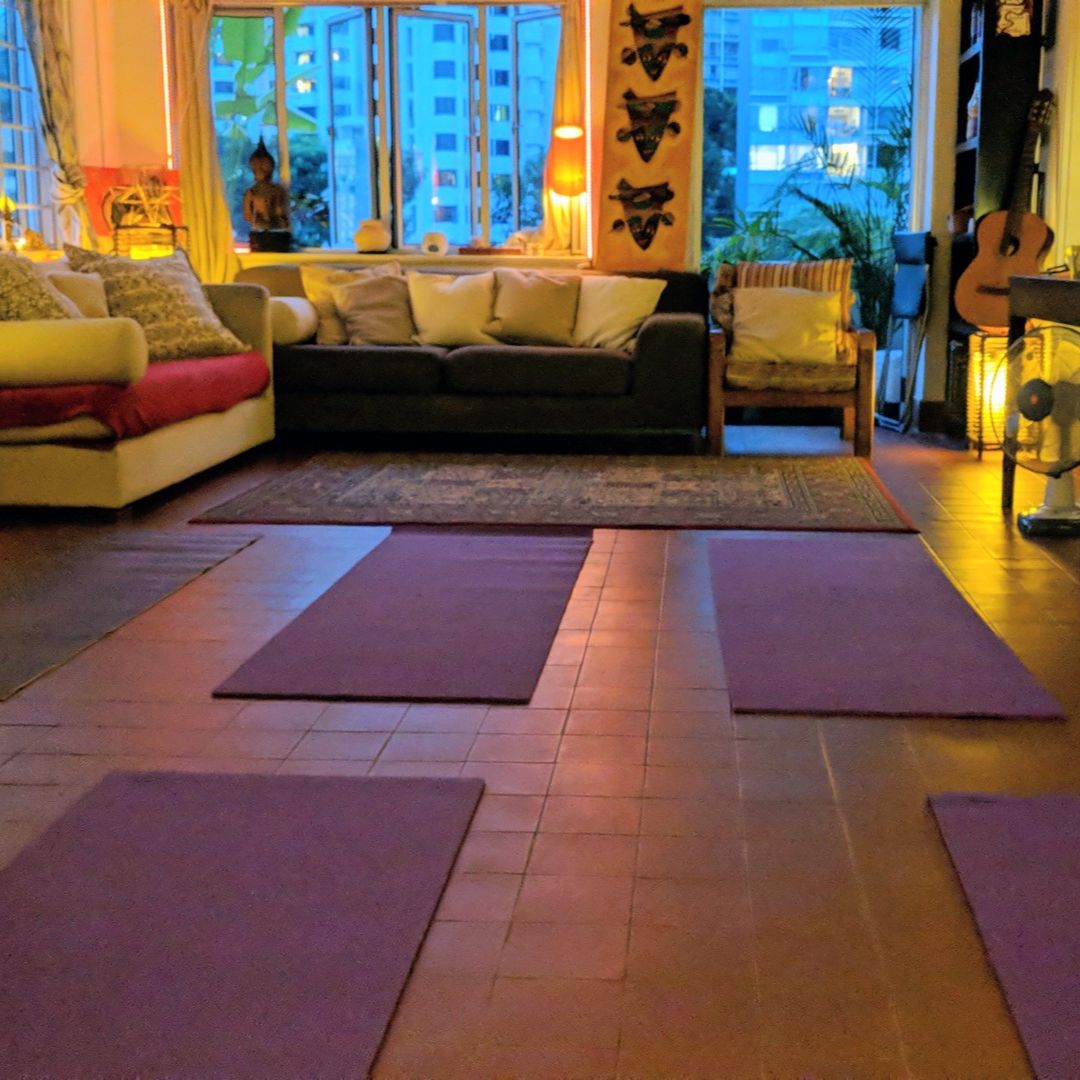 Koru Kundalini class atmosphere with yoga mats and warm lighting